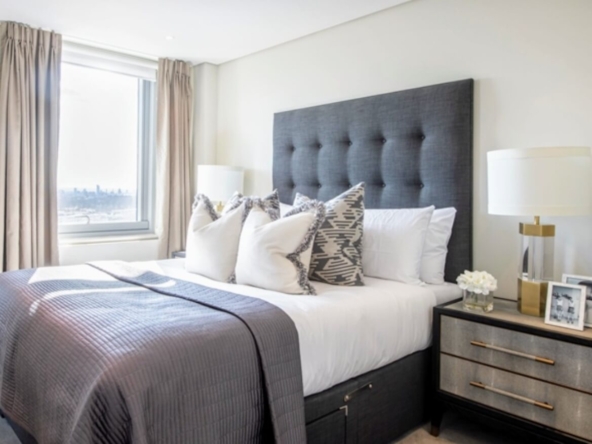Second bedroom with modern decor and city views in Merchant Square penthouse